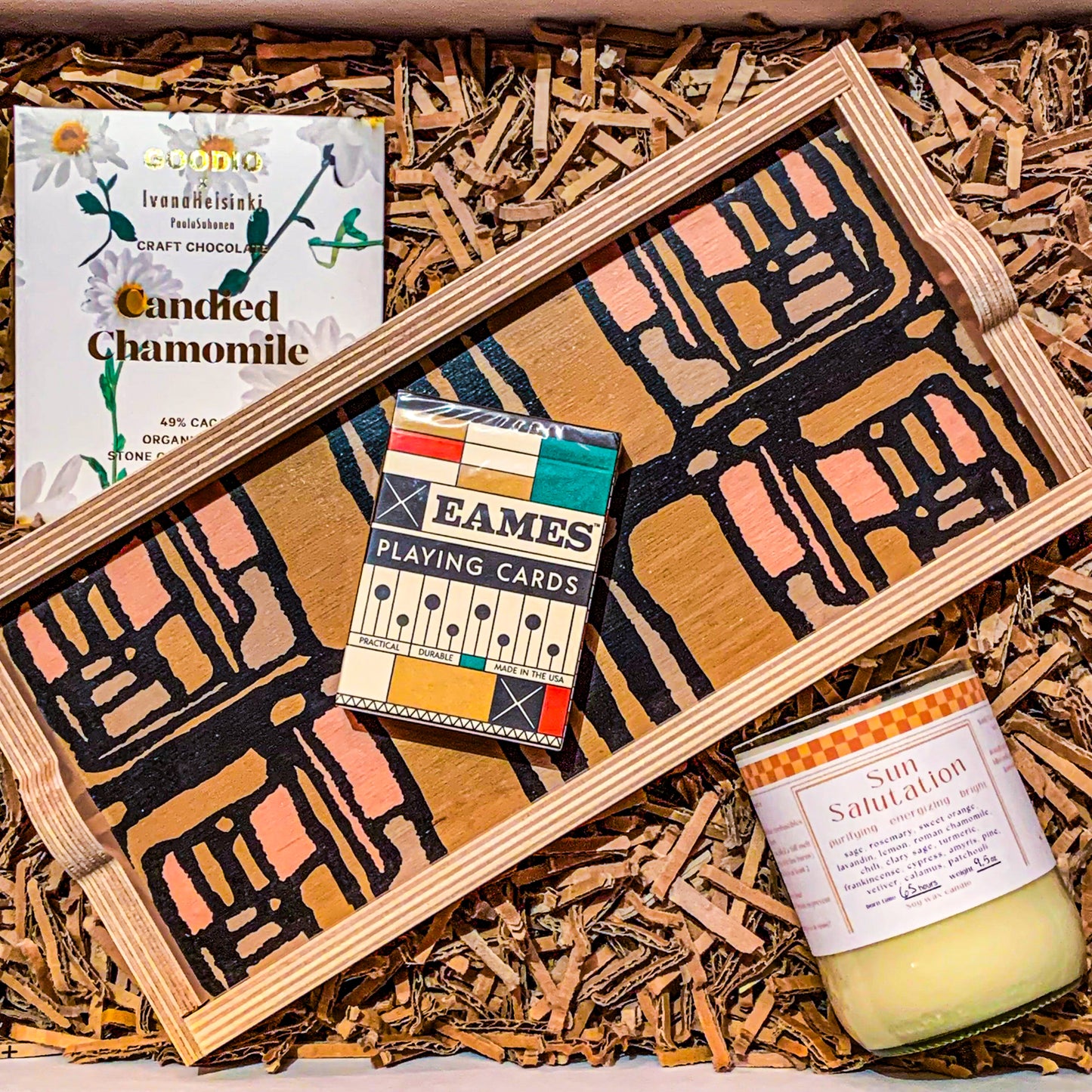 Eco-friendly housewarming Gift box with an olive green decorative tray, a deck of "eames" playing cards, vegan candied chamomile chocolate, and a sage rosemary soy wax candle