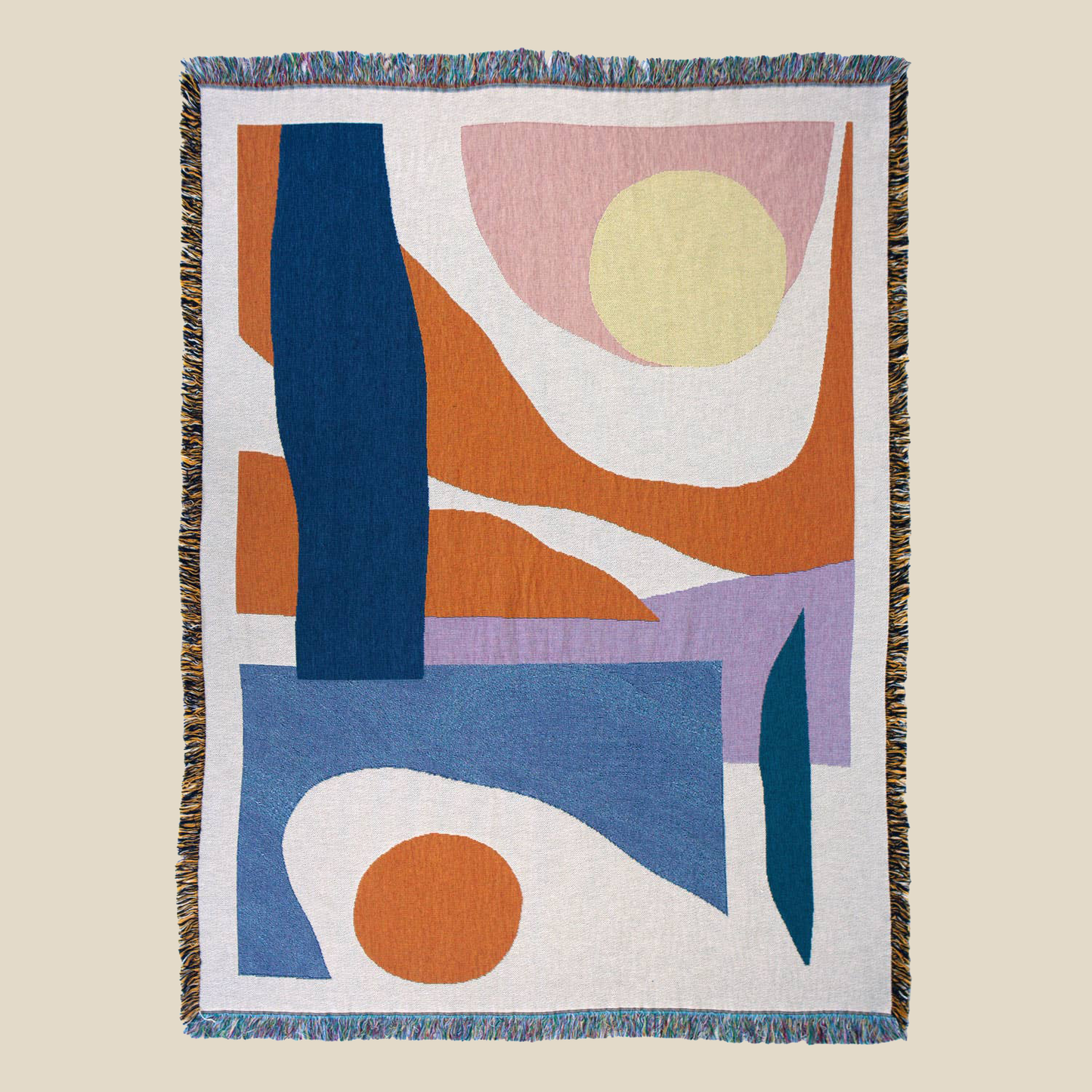 "Essien" throw by Slowdown Studio depicts an abstract sunrise/sunset in earthy orange and blue hues