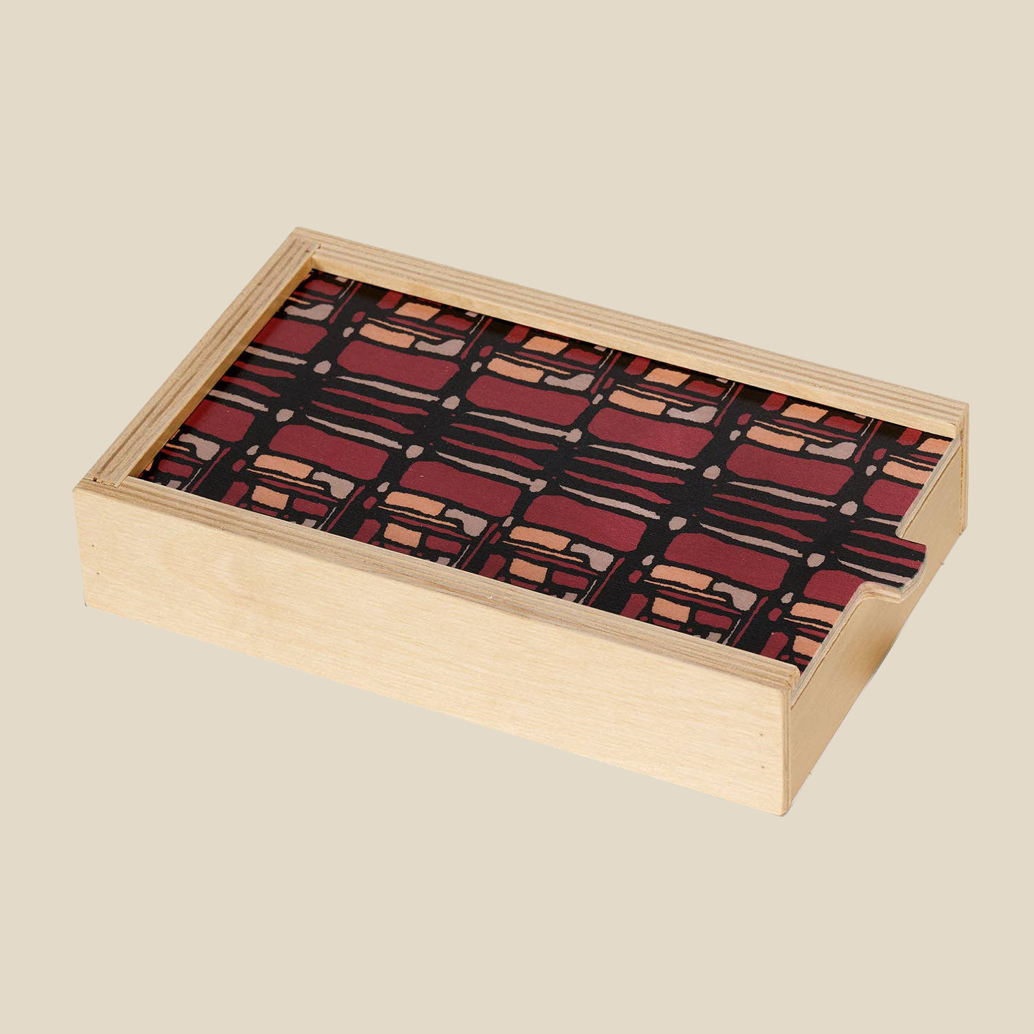 wooden domino set wolfum studio. The birch box has a sliding top which is decorated with a maroon and black pattern. The box is fully closed and shows no domino pieces.