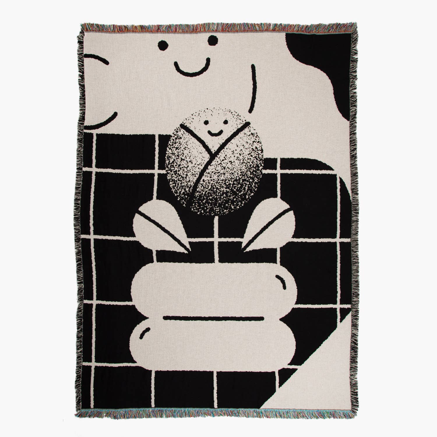 Monochromatic jacquard weave blanket by slowdown studio called "Brando" shows a black & white grid with a small swimming pool, and a ball and cloud with a smiley face