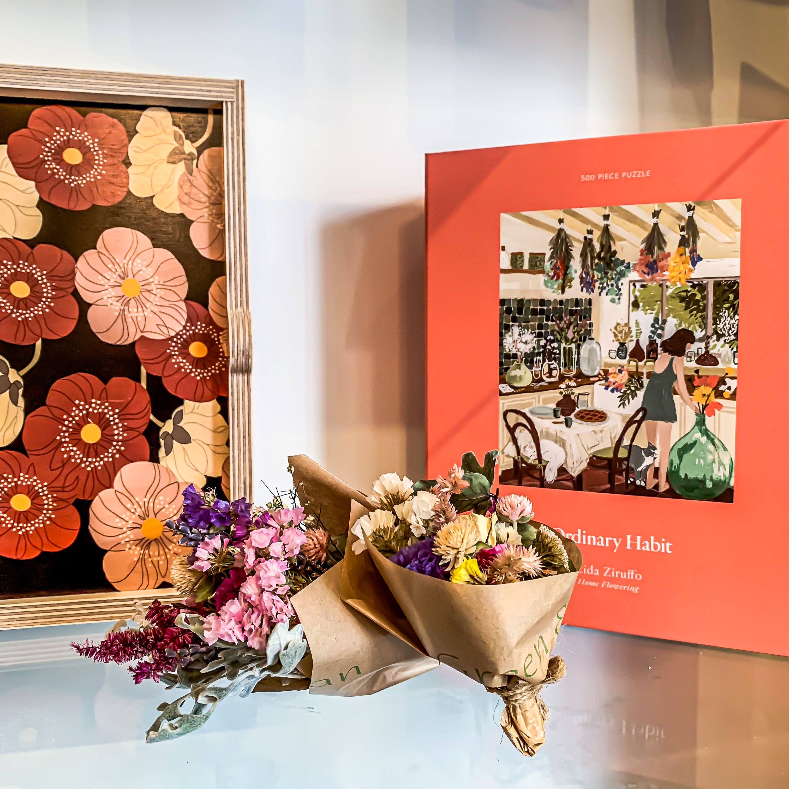 Green & Bean Gift shop cover photo featuring a maroon poppy tray, mini dried bouquets, and Ordinary Habit's Home Flowering 500 piece puzzle